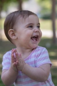 Baby clapping imitation for early language development