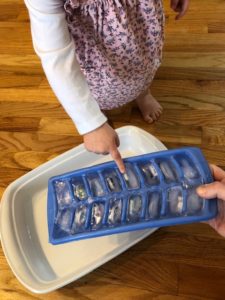 toddler pointing to ice cube activity