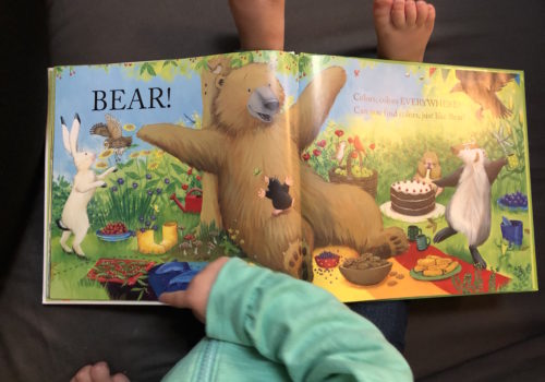 toddler pointing in book to encourage reading in toddlers