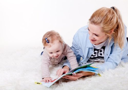 Mother reading with baby to encourage language development